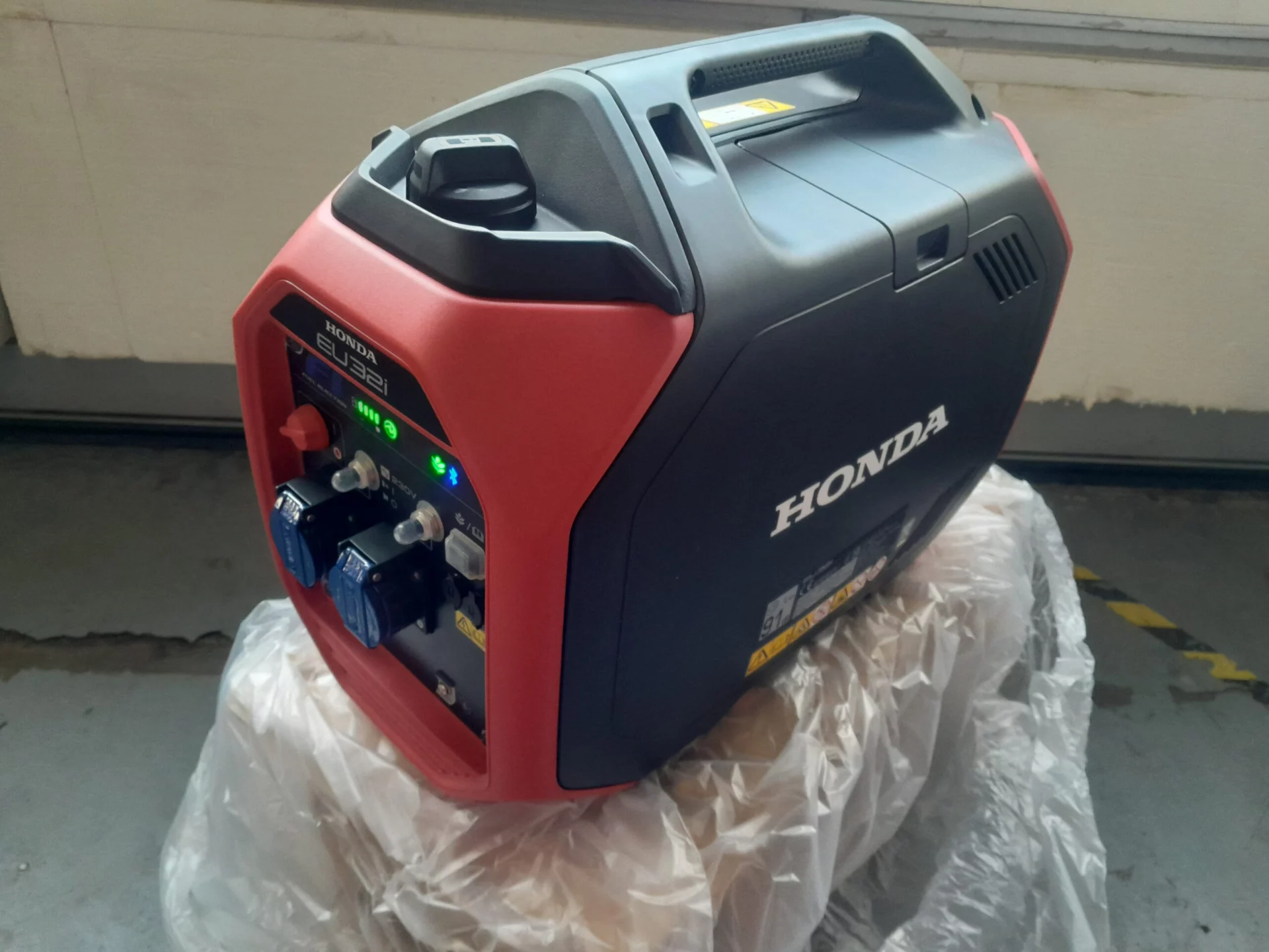 Générateur portable Honda EU32i dans un atelier sur une bâche.